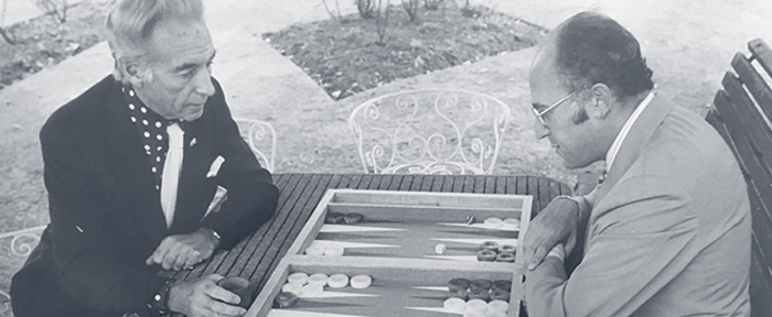 Sir Stanley Matthews (left) playing backgammon with Lewis Deyong (right).